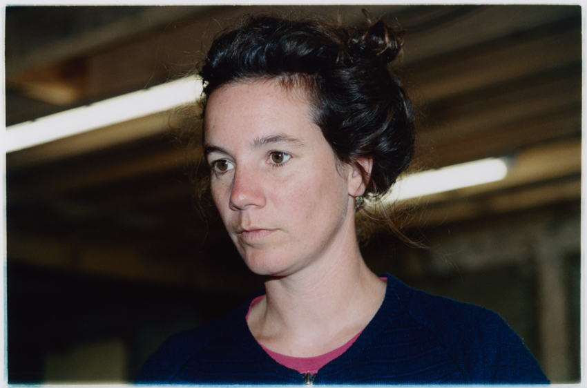Rebekka Deubner, Eyes fixed on the computer to prepare meat orders, concentration required. (Amandine), 2024, series The loving earth (referring to soil that sticks to boots), 2023–2026 Courtesy of the artist.